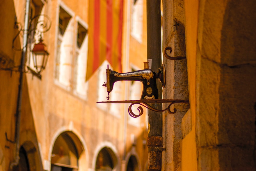 a sewing machine is hanging on the side of a building