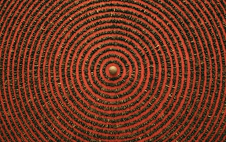 a red and black background with a circular design