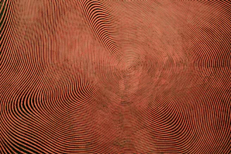 a red and black background with wavy lines