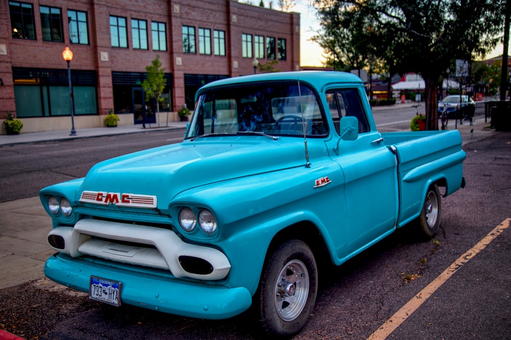 a blue truck parked on the side of the road