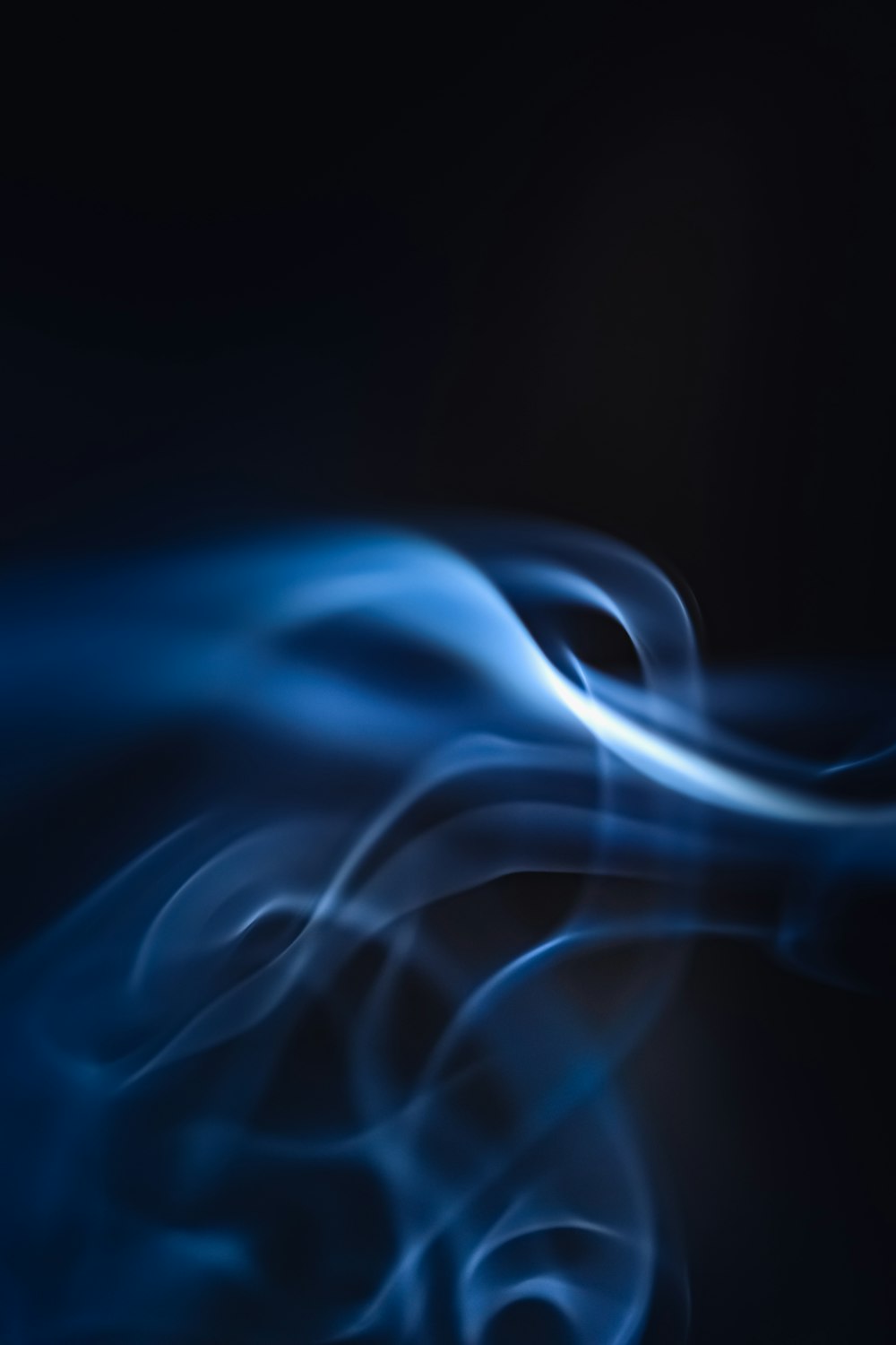 a blue smoke swirl on a black background