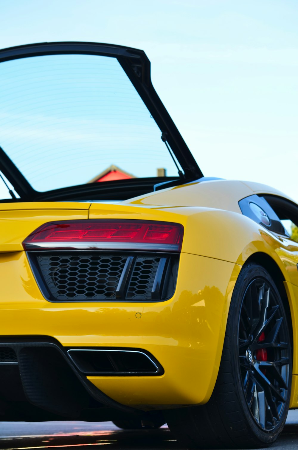 a yellow sports car with its hood open