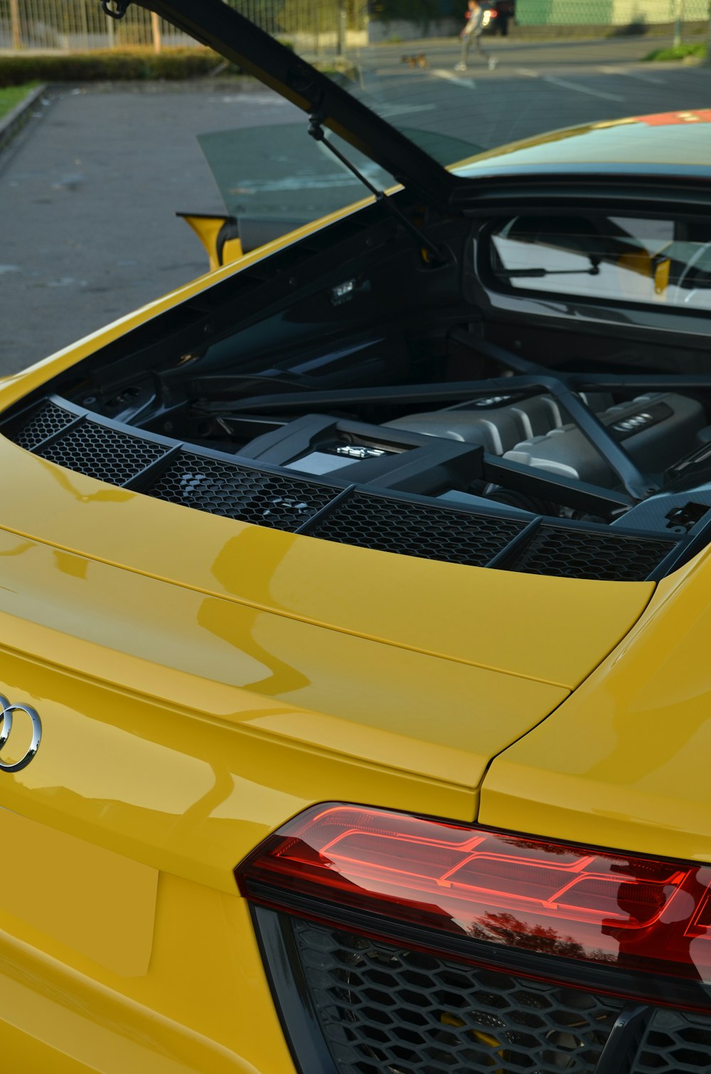 a yellow sports car with its hood open