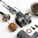 A collection of disassembled metallic mechanical parts arranged on a white surface. The parts include various cylindrical components, screws, and a rusty circular gasket. The components vary in size and shape, with some showing signs of wear.