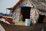 a woman standing on a boat in a body of water