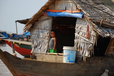 a woman standing on a boat in a body of water