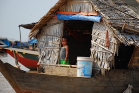 a woman standing on a boat in a body of water