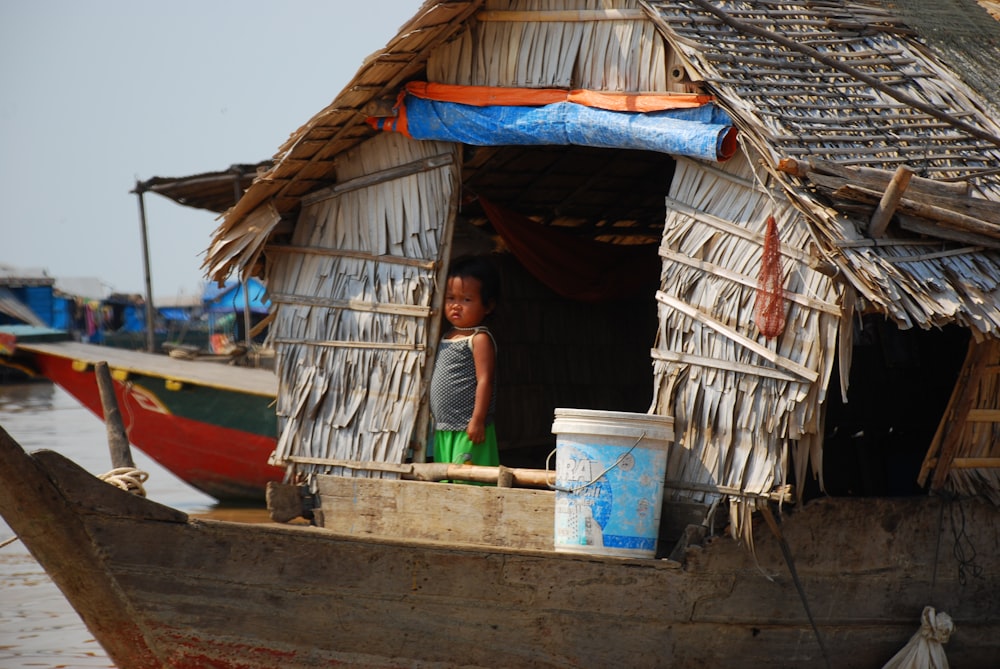 a woman standing on a boat in a body of water