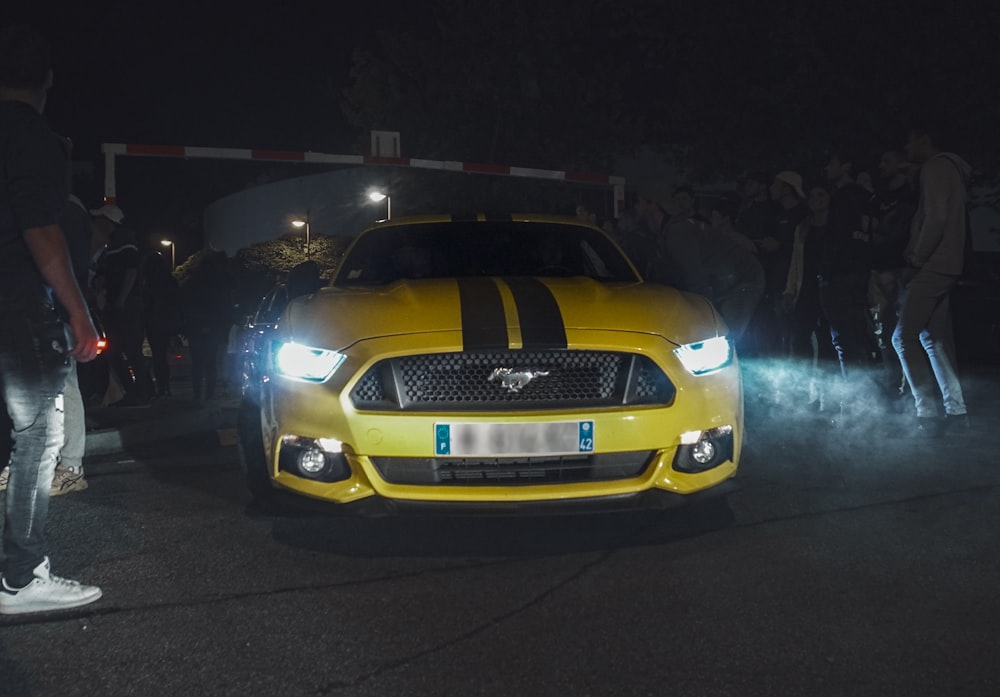 a yellow car with a black stripe on it