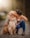 a woman kissing her dog on the cheek