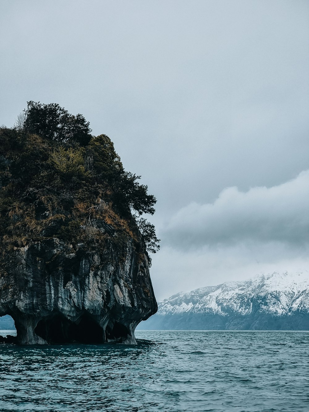 a large rock in the middle of a body of water