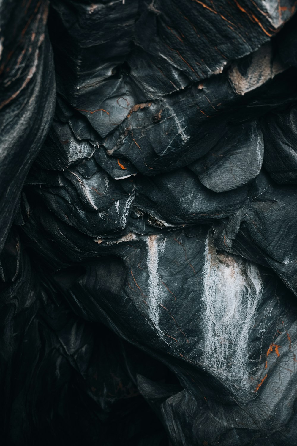 a pile of black plastic bags sitting next to each other