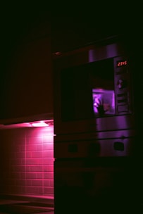 A compact, stylish microwave oven glowing softly on a kitchen counter.