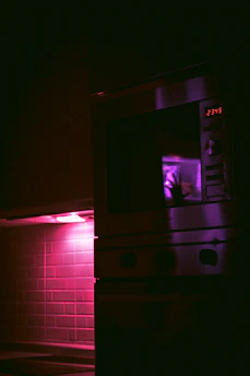 A close-up of a microwave oven with a warm glow inside, highlighting the product's quality.