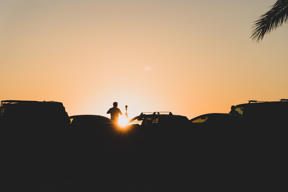 a silhouette of a person standing next to a truck