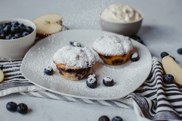 Assortment of rustic muffins with berries and nuts elegantly arranged on a plate