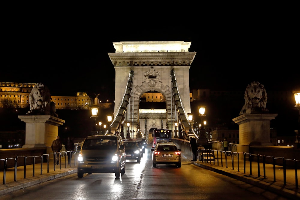 cars driving across a bridge at night time