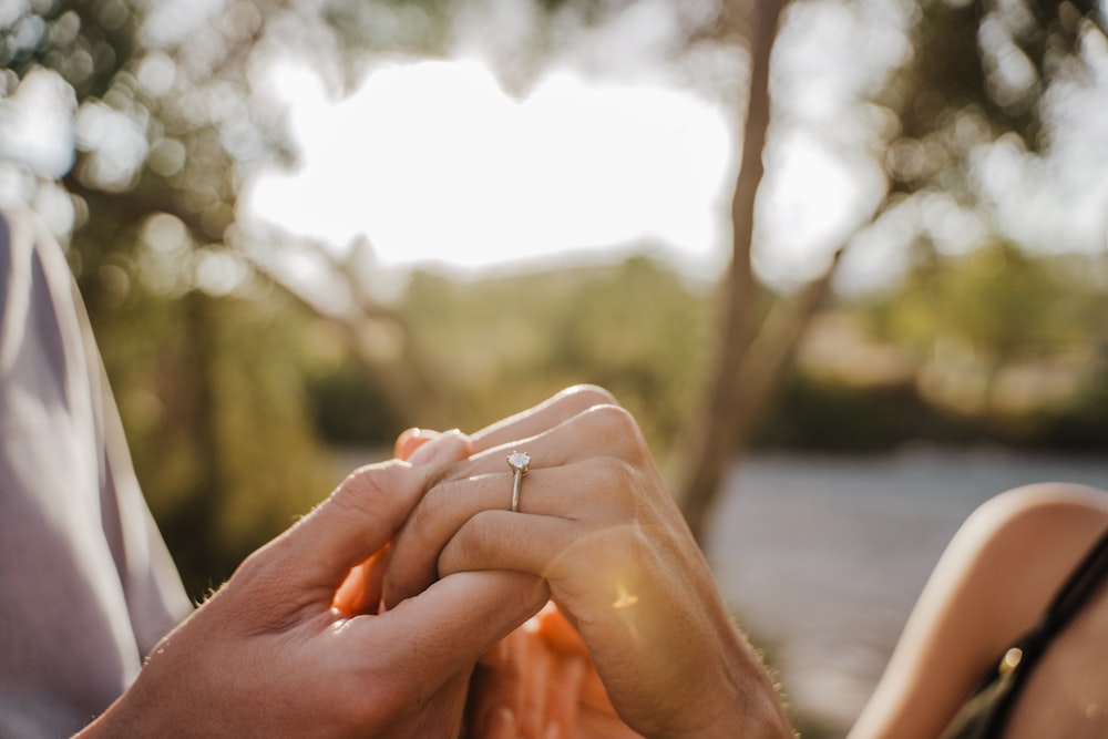 a man and a woman holding hands while holding each other