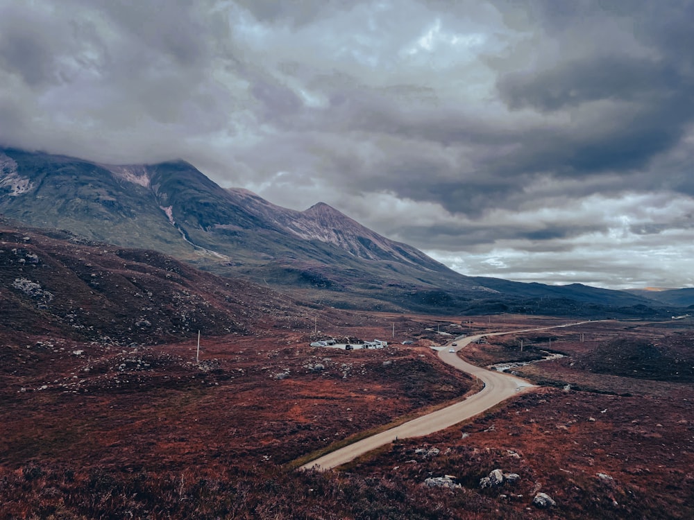 a winding road in the middle of a mountain range