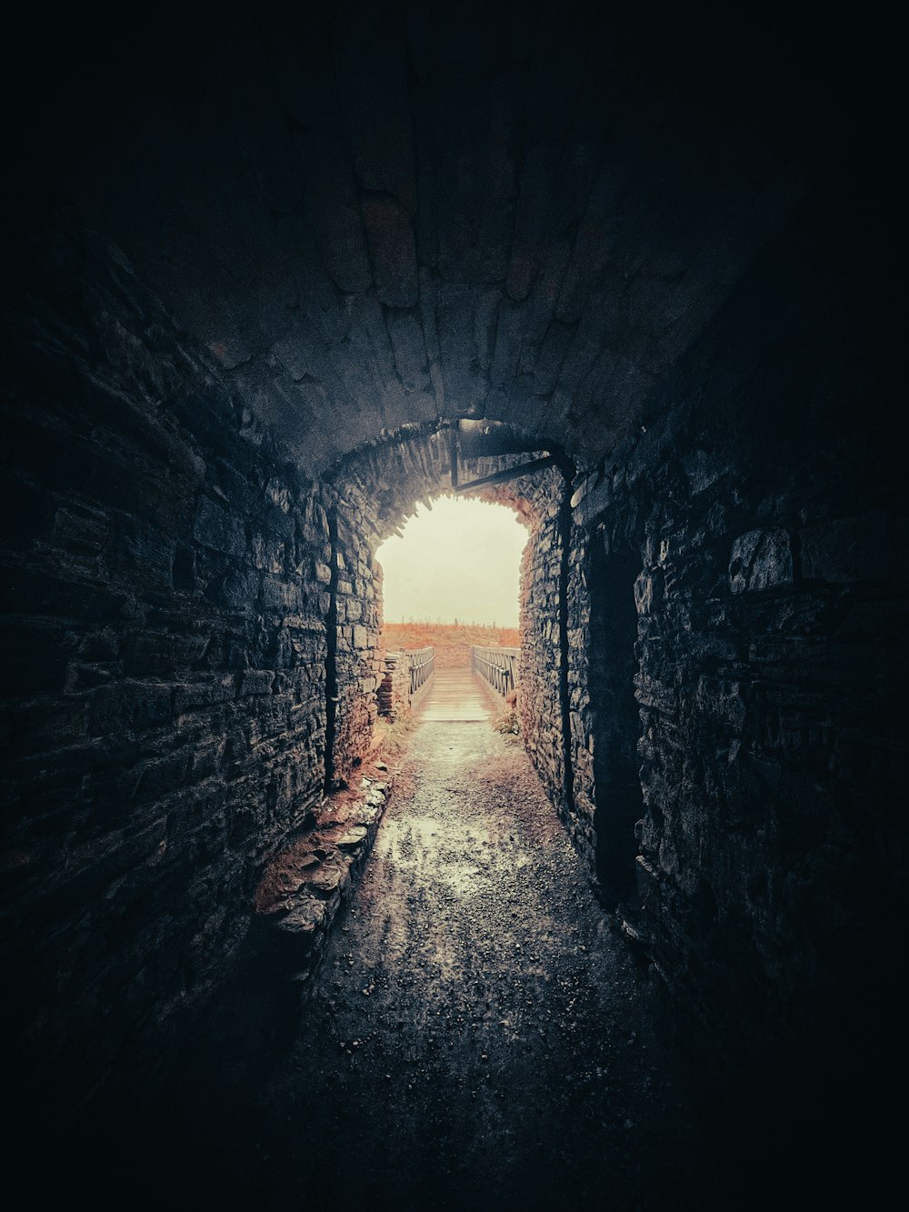 a dark tunnel with a light at the end