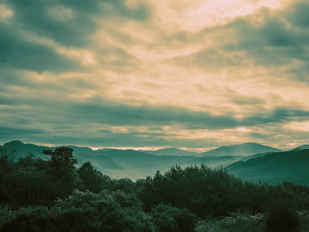 a view of a mountain range with a cloudy sky