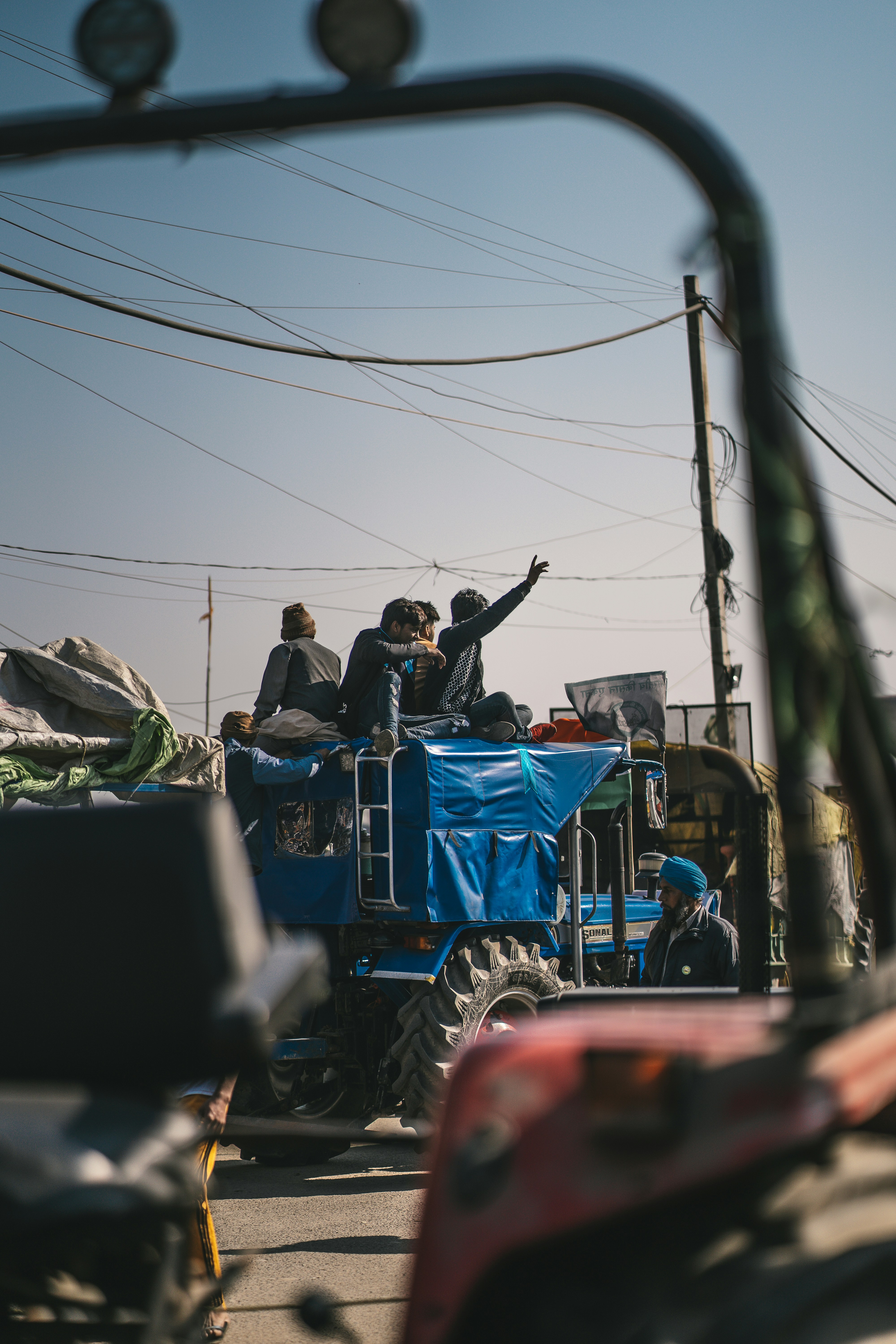 a group of people riding on the back of a blue truck
