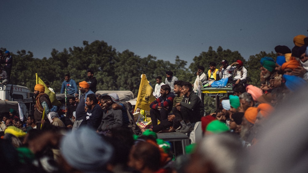 a crowd of people standing around each other