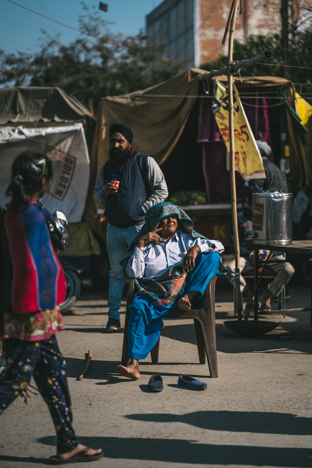 a man sitting on a chair in the middle of a street