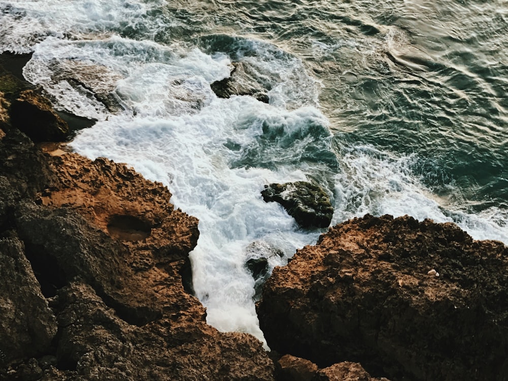 a rocky shore with waves crashing against the rocks