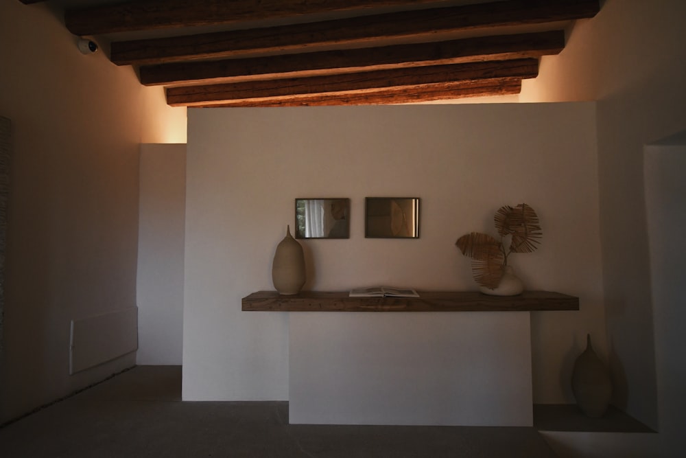 a shelf with two vases on top of it