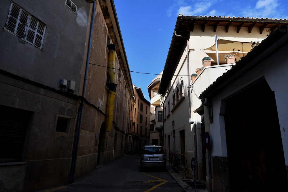 a car is parked in a narrow alley way