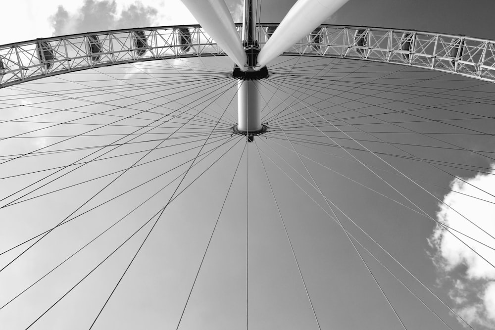 a black and white photo of a large ferris wheel