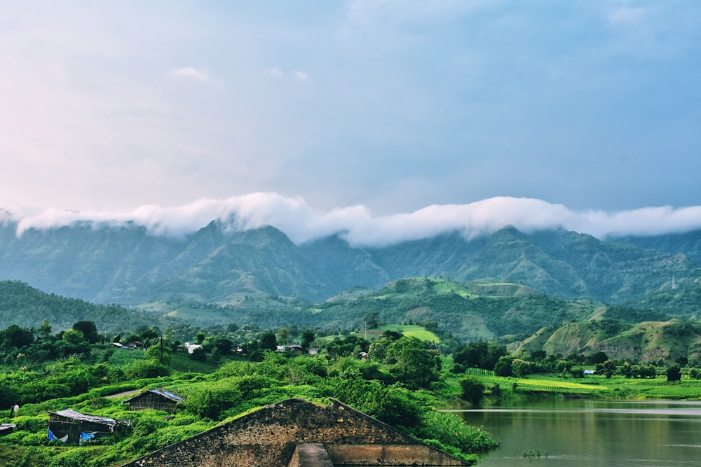 a scenic view of a mountain range with a lake in the foreground