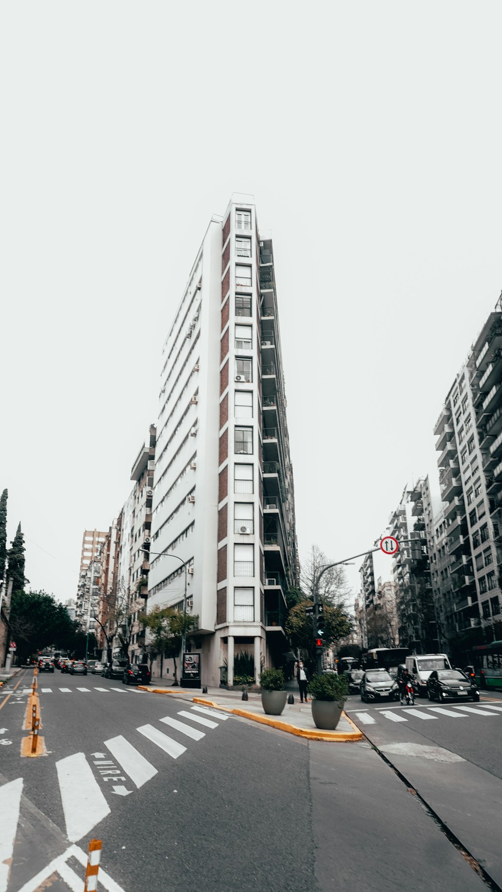 a city street with tall buildings and a yellow fire hydrant