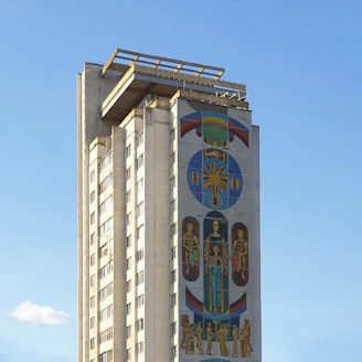 a tall building with a mural on the side of it