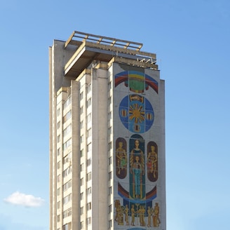 a tall building with a mural on the side of it
