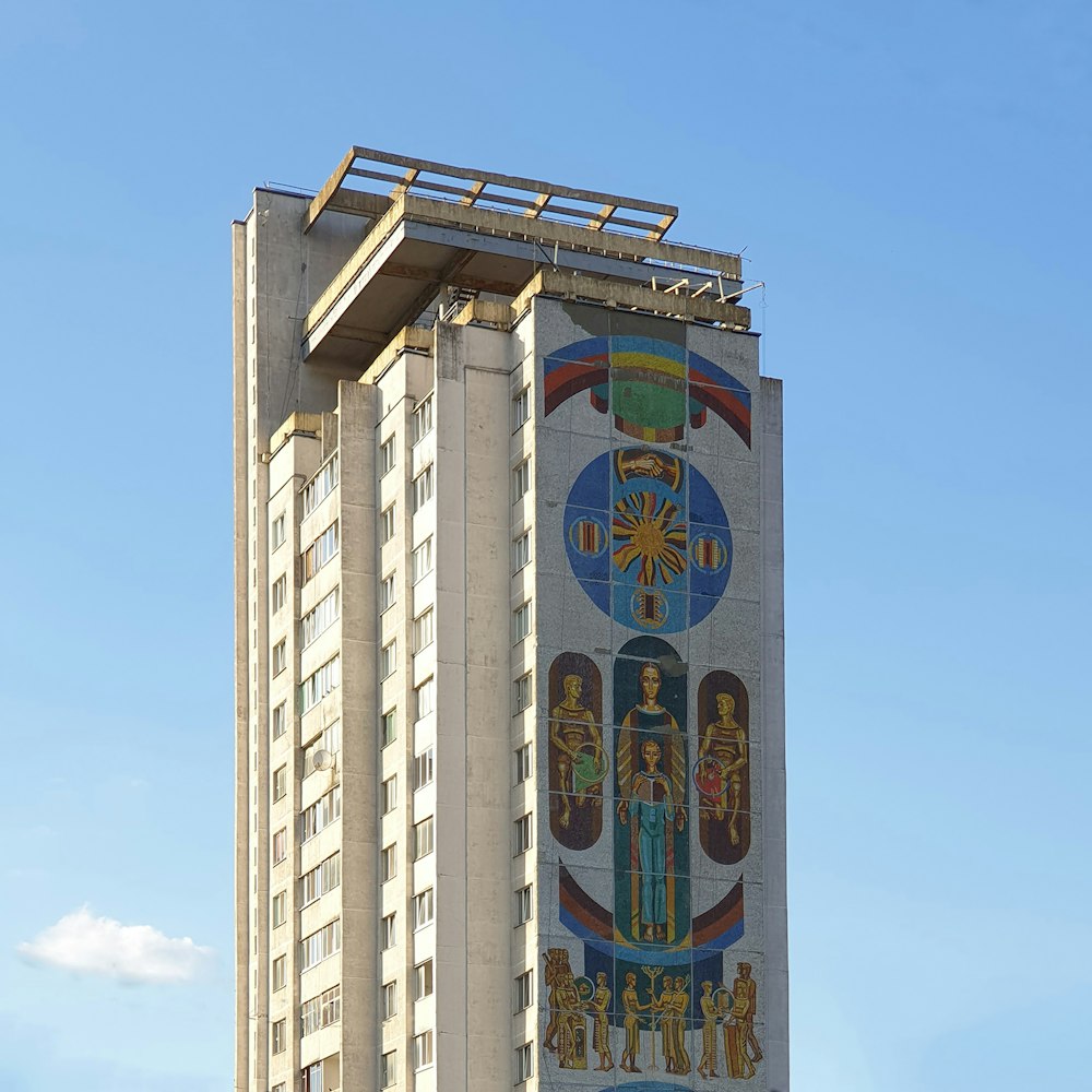 a tall building with a mural on the side of it