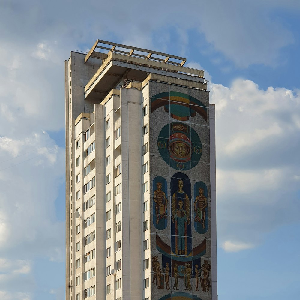 a tall building with a mural on the side of it