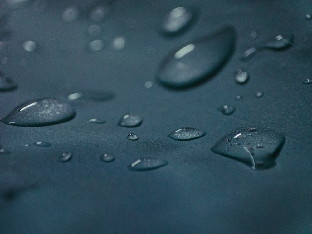 a close up of water droplets on a blue surface
