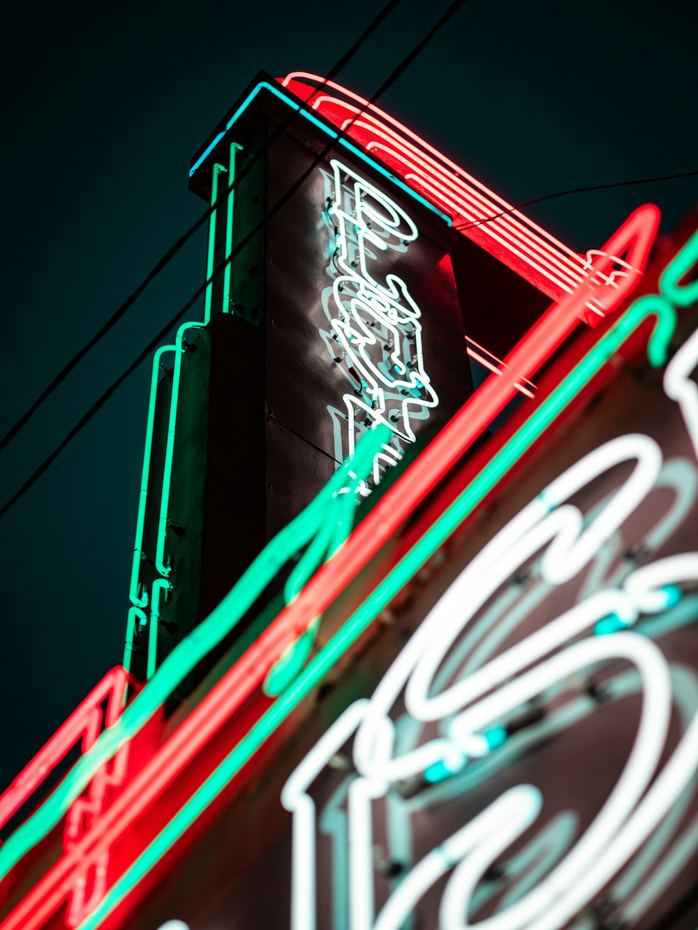 a neon sign is lit up on the side of a building