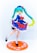 A figure of an anime character with teal twin-tails and bright green eyes, dressed in a navy blue dress adorned with red flowers and a red bow. The character stands on one leg with the other slightly raised, showcasing white socks and black shoes. The dress has white frilled hem and the figure is mounted on an orange circular base with white decorative patterns.