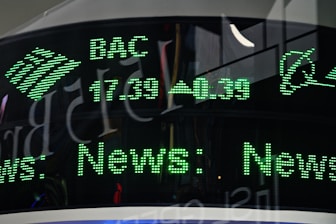 a close up of a clock with green numbers