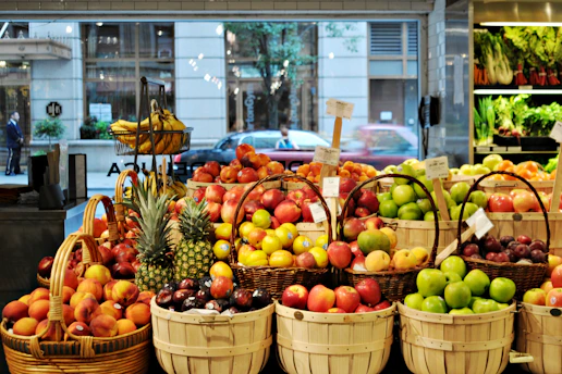 a bunch of baskets filled with different types of fruit