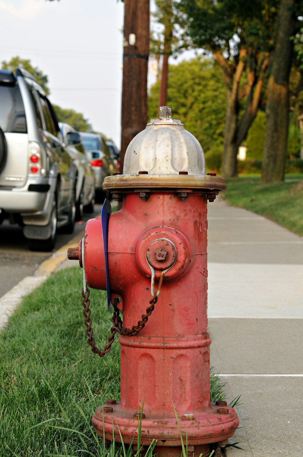 a red fire hydrant sitting on the side of a road