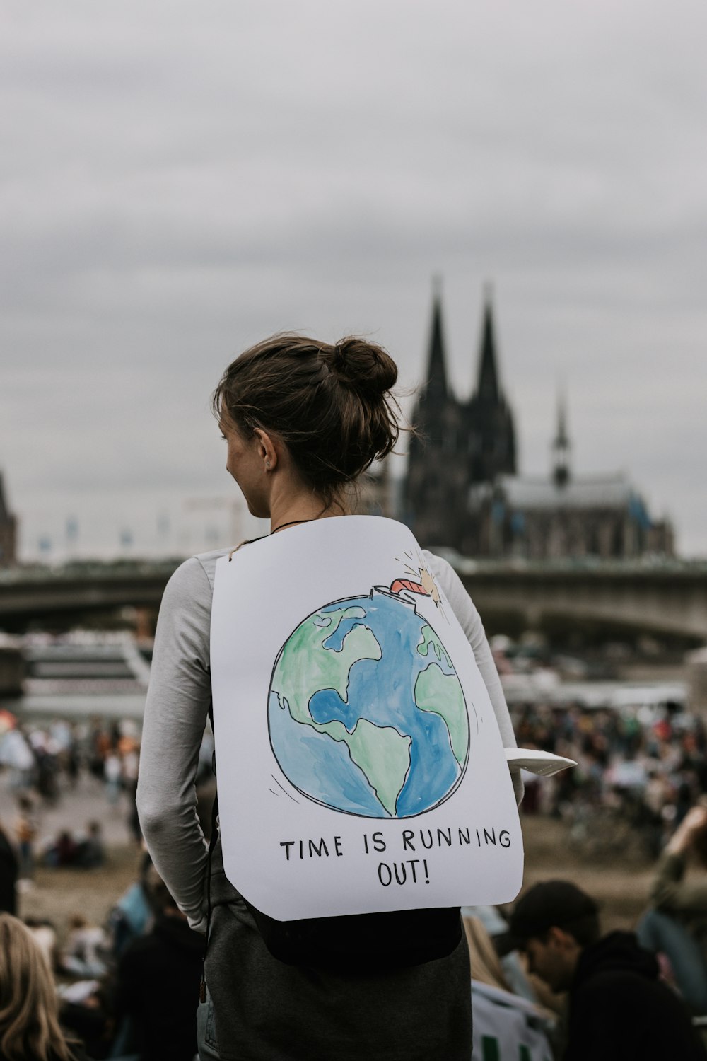 a woman holding a sign that says time is running out