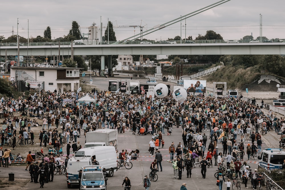 a large group of people standing in a parking lot