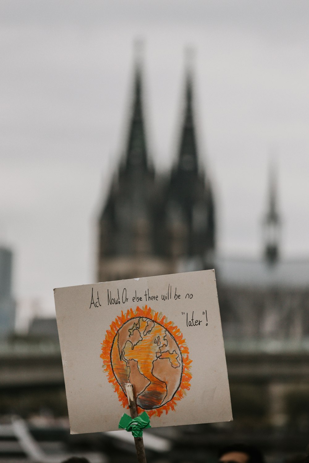 a person holding a sign in front of a castle