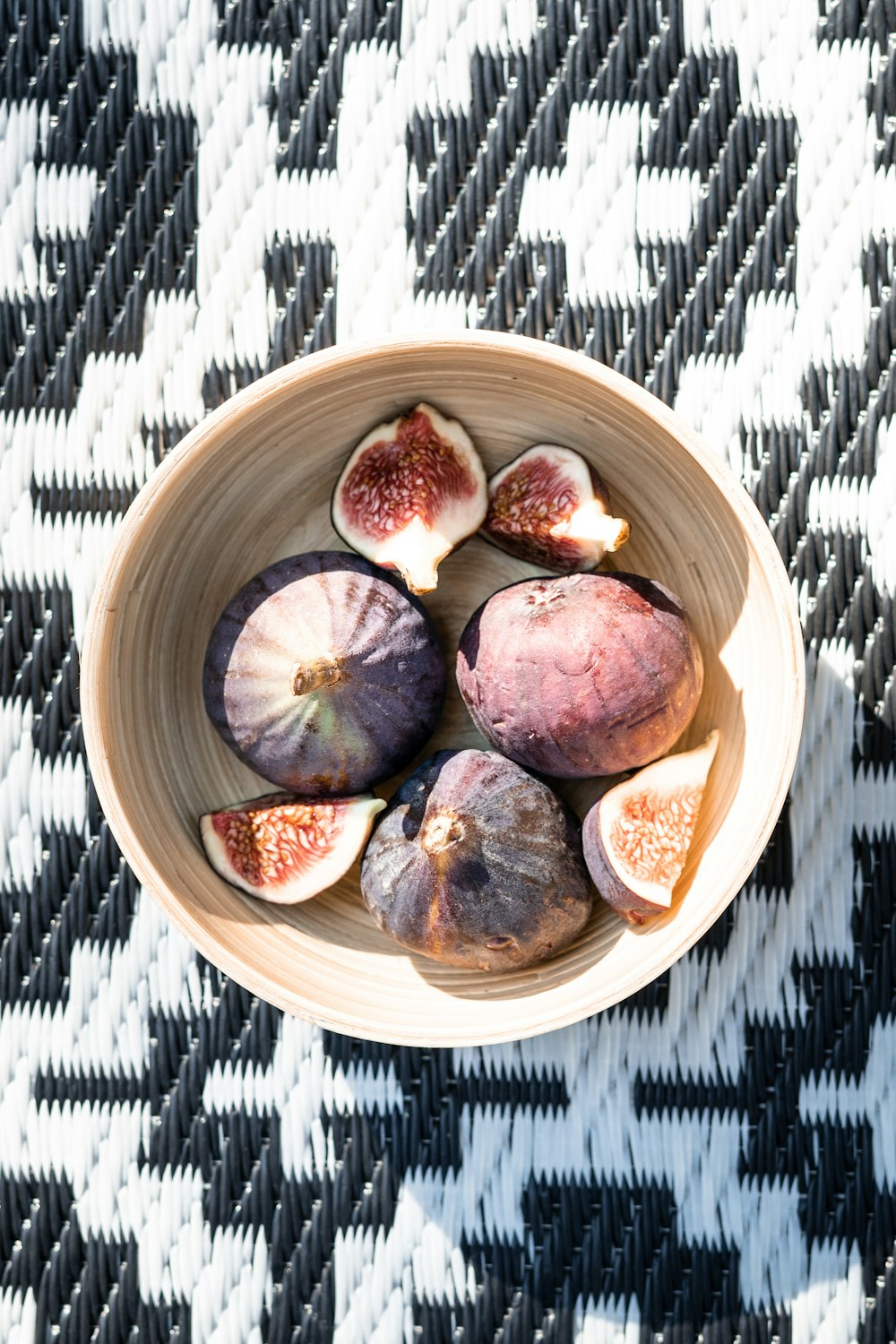 a bowl filled with sliced figs on top of a table