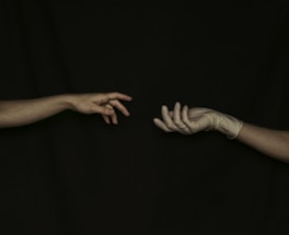 A close-up of a hand wearing a durable tactical glove, reaching out as if ready to connect.