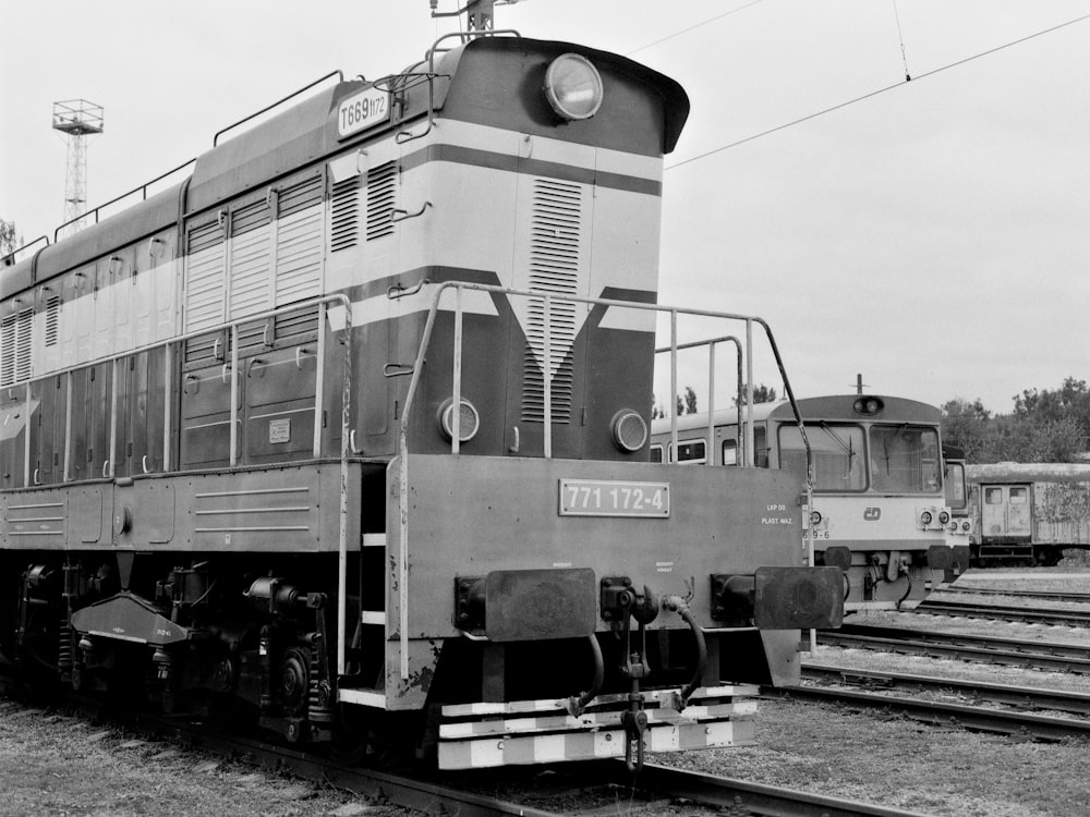 a black and white photo of a train on the tracks